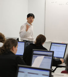Students in a computer lab work on an assignment in class
