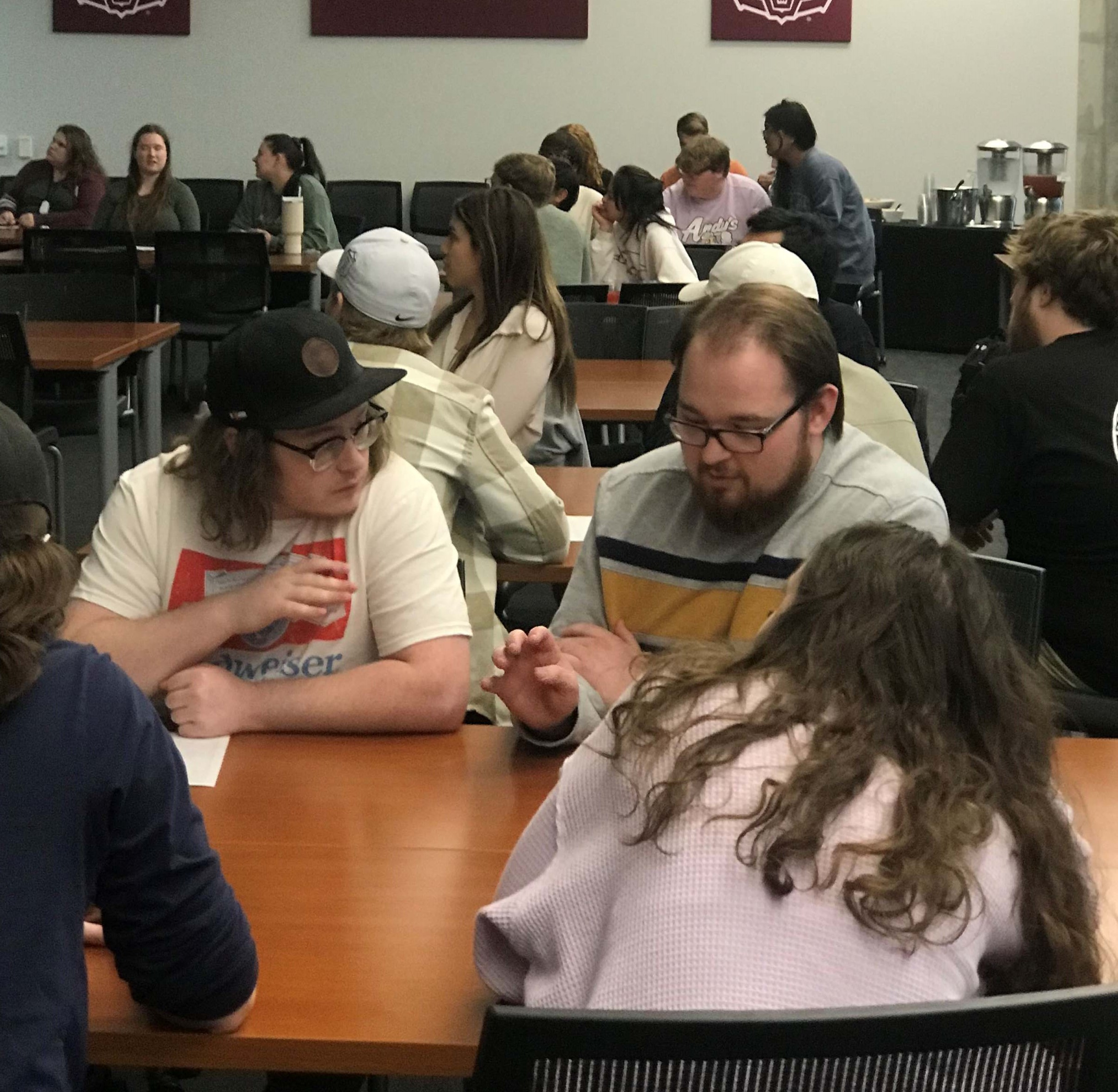 Students at a table working on trivia night