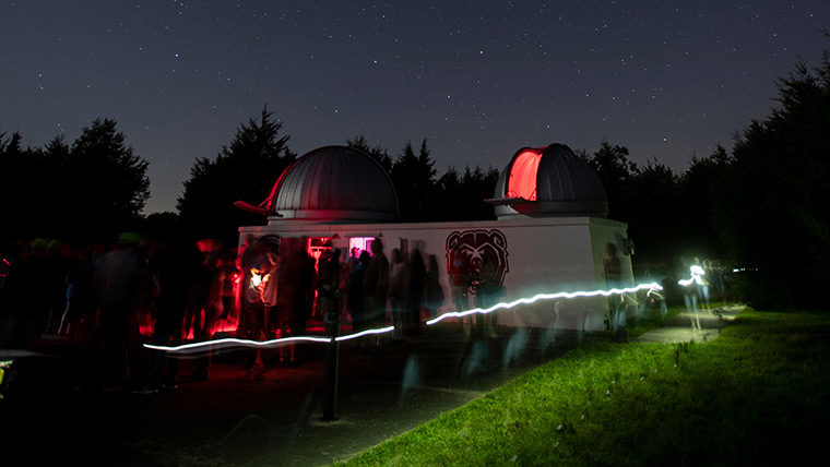 Baker Observatory lit up at night.
